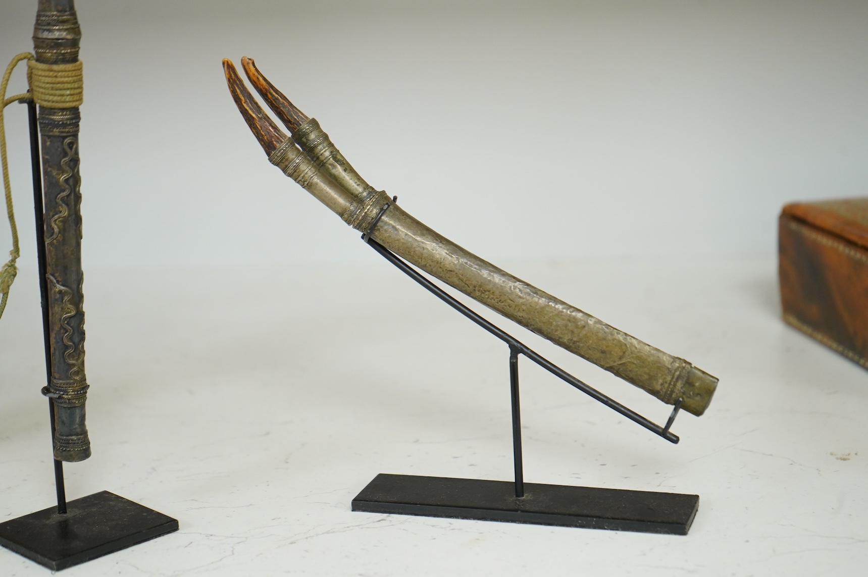 A Burmese dagger dha, blade 14.5cm, hilt and sheath covered in sheet silver filigree decoration, together with an unusual pair of small Burmese knives with silver mounted stag horn handles and silver covered sheath, both